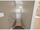 A view of the hallway from the top of the stairs with a small window and neutral wall colors at 5359 Compass Pt, Oxford, FL 34484