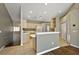 Open kitchen featuring tile flooring, light countertops and wooden cabinetry, and a view of the Living Room at 5359 Compass Pt, Oxford, FL 34484
