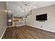 Open concept living space with wood floors connecting the living room and kitchen at 5359 Compass Pt, Oxford, FL 34484