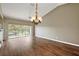 Bright living room featuring wood floors, vaulted ceilings, and access to a private balcony at 5359 Compass Pt, Oxford, FL 34484