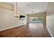 Bright living room with wood floors, vaulted ceiling, and sliding glass doors to the balcony at 5359 Compass Pt, Oxford, FL 34484