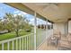Screened-in patio with fan and exterior view of landscaped green space at 5359 Compass Pt, Oxford, FL 34484