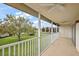 Screened-in patio with fan and exterior view of landscaped green space at 5359 Compass Pt, Oxford, FL 34484
