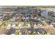 Expansive aerial view of a residential community with numerous homes, green spaces, and nearby lakes at 5978 Conley Ct, The Villages, FL 32163