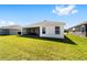 Expansive backyard with a screened lanai, offering a serene outdoor retreat at 5978 Conley Ct, The Villages, FL 32163