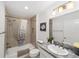 Tiled bathroom with a shower-tub combo and granite vanity at 5978 Conley Ct, The Villages, FL 32163