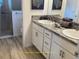 Modern bathroom with a double sink vanity, granite countertops, and a glass-enclosed shower for a spa-like experience at 5978 Conley Ct, The Villages, FL 32163