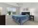 Bedroom featuring a window with outdoor views and neutral carpet flooring at 5978 Conley Ct, The Villages, FL 32163