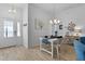 Light-filled dining area showcasing modern decor, stylish light fixture, and a welcoming ambiance at 5978 Conley Ct, The Villages, FL 32163