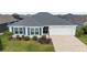 Single-story home with a two-car garage, manicured lawn, and blue shutters on the windows at 5978 Conley Ct, The Villages, FL 32163