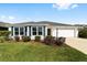 Charming one-story home with white siding, well-manicured lawn and blue shutters at 5978 Conley Ct, The Villages, FL 32163