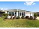 Beautiful one-story home with white siding, green lawn, and inviting curb appeal at 5978 Conley Ct, The Villages, FL 32163