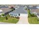 Well-kept single-story home with a driveway, two-car garage, manicured lawn, and blue shutters at 5978 Conley Ct, The Villages, FL 32163
