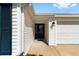 Inviting entrance features a black front door, well maintained walkway, and attached garage at 5978 Conley Ct, The Villages, FL 32163