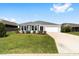 Charming single-story home with a well-maintained lawn and a two-car attached garage at 5978 Conley Ct, The Villages, FL 32163