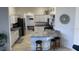Well-equipped kitchen with granite countertops, modern appliances, and convenient bar stool seating at 5978 Conley Ct, The Villages, FL 32163