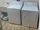 Functional laundry room with washer, dryer, and utility sink for added convenience at 5978 Conley Ct, The Villages, FL 32163