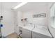 Convenient laundry room with washer, dryer, and utility sink at 5978 Conley Ct, The Villages, FL 32163