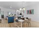 Bright, open-concept living space with modern decor and wood-look tile flooring at 5978 Conley Ct, The Villages, FL 32163