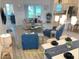 Bright living room with stylish furniture, modern lighting, and sliding glass doors to the outdoor space at 5978 Conley Ct, The Villages, FL 32163