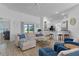 Inviting living room featuring a plush sofa, stylish armchairs, and ample natural light at 5978 Conley Ct, The Villages, FL 32163