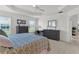 This bedroom includes a large dresser, carpet flooring, and windows with outside views at 5978 Conley Ct, The Villages, FL 32163