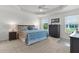Bright bedroom featuring a tray ceiling, neutral carpet, and coordinated furniture set at 5978 Conley Ct, The Villages, FL 32163