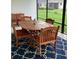 Inviting patio with outdoor dining set on blue patterned rug, perfect for relaxation at 5978 Conley Ct, The Villages, FL 32163