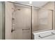 Neutral tiled shower with frameless glass doors and dual shower heads at 5978 Conley Ct, The Villages, FL 32163