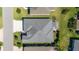 Aerial view of a single-Gathering home with a gray roof, driveway, and pergola in a well-maintained neighborhood at 6083 Delphina Loop, The Villages, FL 32163