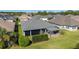 Aerial view of home showing screened patio with pergola and privacy in a lush, green lawn at 6083 Delphina Loop, The Villages, FL 32163