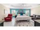 Spacious primary bedroom with tray ceiling, ensuite bathroom, neutral carpeting and ample natural light at 6083 Delphina Loop, The Villages, FL 32163
