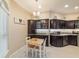 Breakfast nook with dark wood cabinets, decorative shelves, tile floor, and a bright window, perfect for casual dining at 6083 Delphina Loop, The Villages, FL 32163