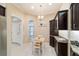 Bright and cheerful breakfast nook with a table and chairs, dark cabinets, and tile flooring for easy maintenance at 6083 Delphina Loop, The Villages, FL 32163