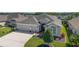 Beautiful single-story home with a spacious two-car garage, well-maintained lawn, and charming front entrance at 6083 Delphina Loop, The Villages, FL 32163