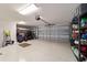 Spacious two-car garage with epoxy flooring, ample storage space, and overhead lighting at 6083 Delphina Loop, The Villages, FL 32163