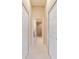 Hallway with view of en-suite bathroom featuring tile shower at 6083 Delphina Loop, The Villages, FL 32163