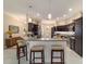 Kitchen with granite countertops, pendant lighting and breakfast bar with seating at 6083 Delphina Loop, The Villages, FL 32163
