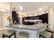 Kitchen featuring a breakfast bar with pendant lighting and a modern backsplash at 6083 Delphina Loop, The Villages, FL 32163