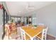 Comfortable lanai with a dining table, chairs, ceiling fans and sliding doors for indoor/outdoor living at 6083 Delphina Loop, The Villages, FL 32163