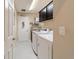 Laundry room with washer, dryer, sink, and storage at 6083 Delphina Loop, The Villages, FL 32163