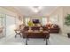 Inviting living room featuring neutral tones, comfortable furniture, and a view of the patio at 6083 Delphina Loop, The Villages, FL 32163