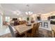 Open concept living room with dining area and kitchen beyond, ideal for entertaining at 6083 Delphina Loop, The Villages, FL 32163