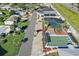 Community aerial view showcasing shuffleboard, pool, and clubhouse amenities offering residents many options at 710 Dolphin Dr, Tavares, FL 32778
