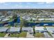 Wide aerial view of a charming neighborhood featuring waterfront homes, canals, and mature trees at 710 Dolphin Dr, Tavares, FL 32778