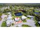 Aerial view of home featuring a pond and mature landscaping at 710 Dolphin Dr, Tavares, FL 32778