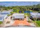 Aerial view showcasing home with a charming carport and scenic pond views at 710 Dolphin Dr, Tavares, FL 32778