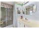 This bathroom has a neutral color palette, vanity, and walk-in shower at 710 Dolphin Dr, Tavares, FL 32778