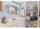 This is a full bathroom with a seashell valance and access to the bedroom at 710 Dolphin Dr, Tavares, FL 32778