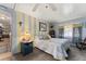 This bedroom features a queen bed, striped accent wall, and cottagecore decor at 710 Dolphin Dr, Tavares, FL 32778